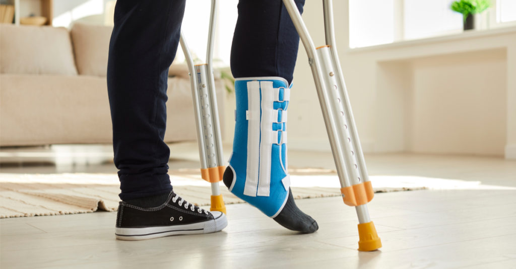 workers' comp injury with male walking on crutches while on workers' compensation